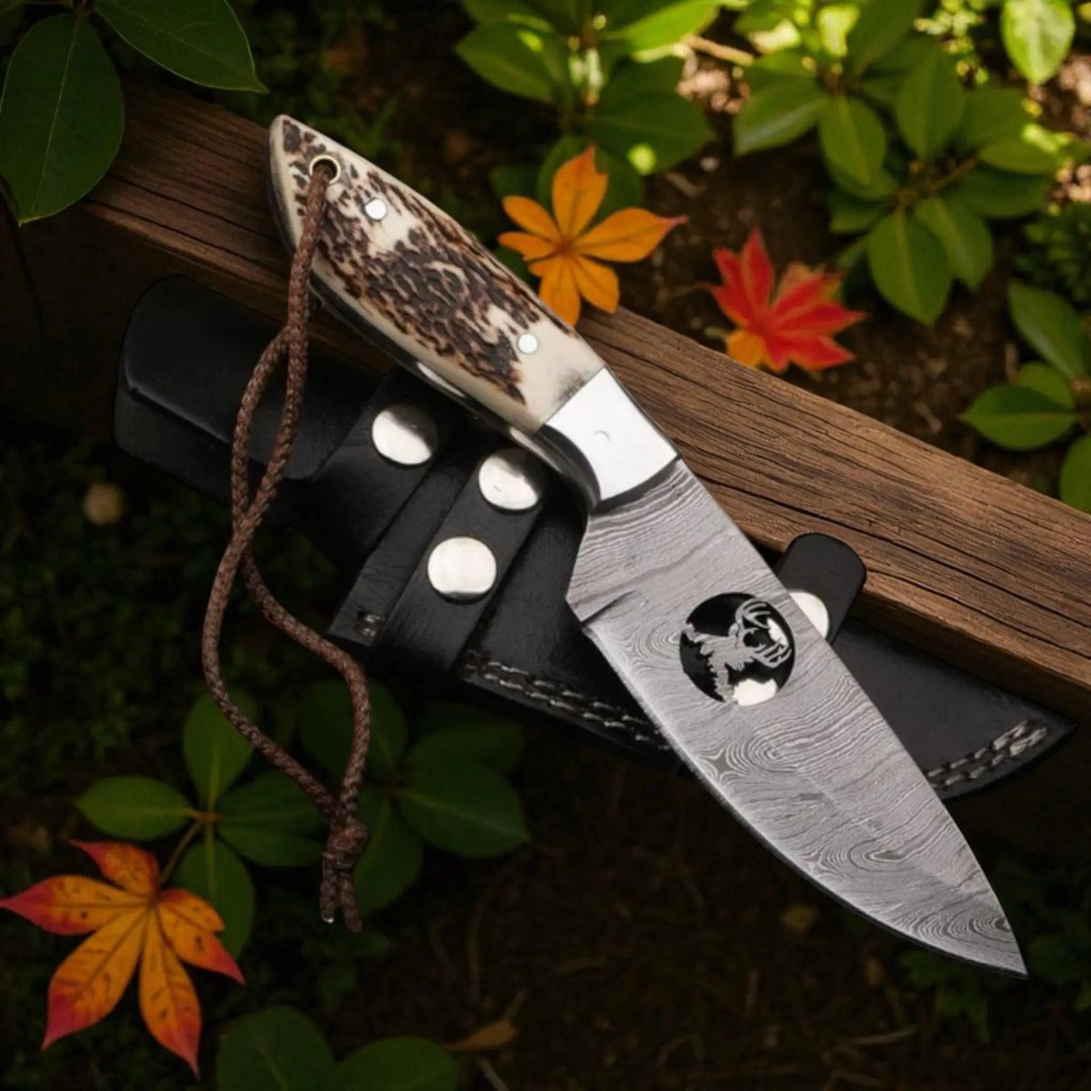 Handmade Damascus steel skinning knife with stag horn handle and black leather sheath – Arham Cutlery.