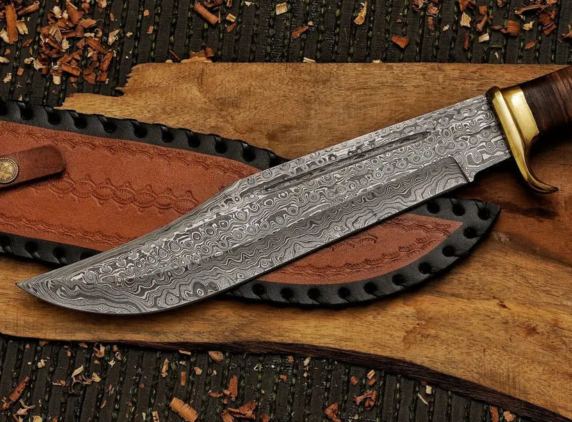 A fixed-blade knife with a patterned Damascus steel blade, a brown wooden handle, and a brass guard, displayed diagonally on a wooden board with a brown leather sheath.