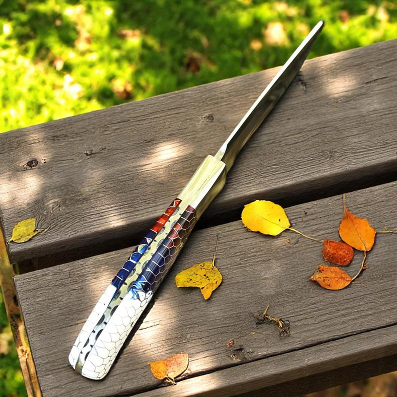 Handcrafted D2 steel knife with colorful honeycomb resin handle held outdoors – Arham Cutlery