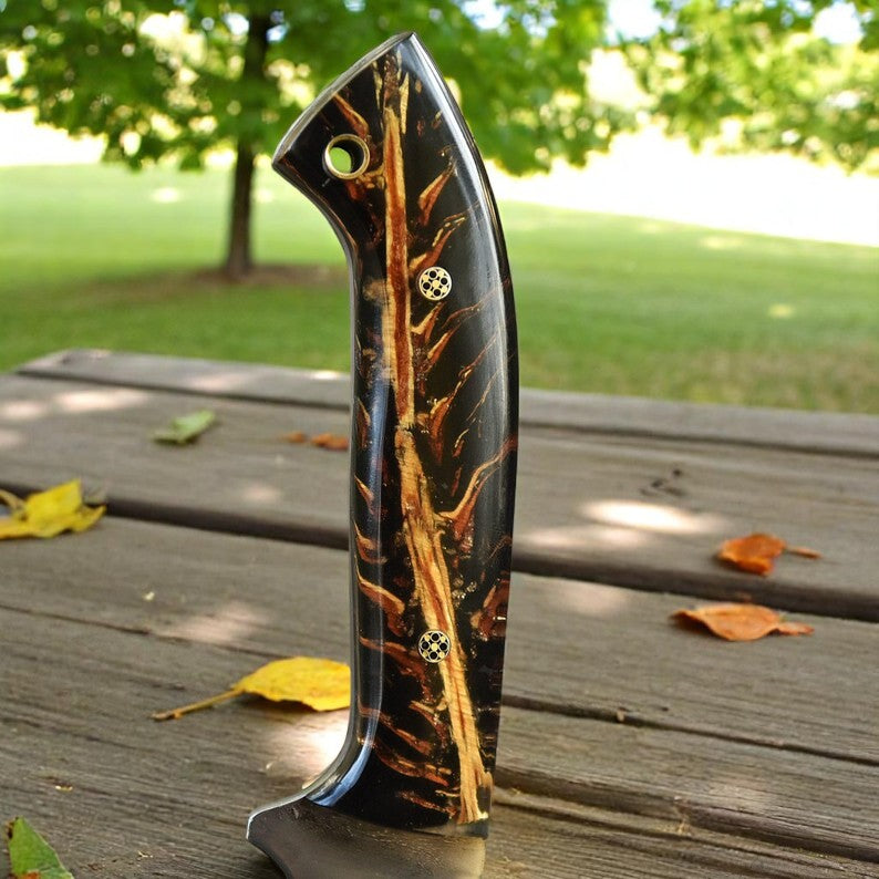 Handmade D2 steel hunting knife with black and amber resin handle on wooden surface – Arham Cutlery