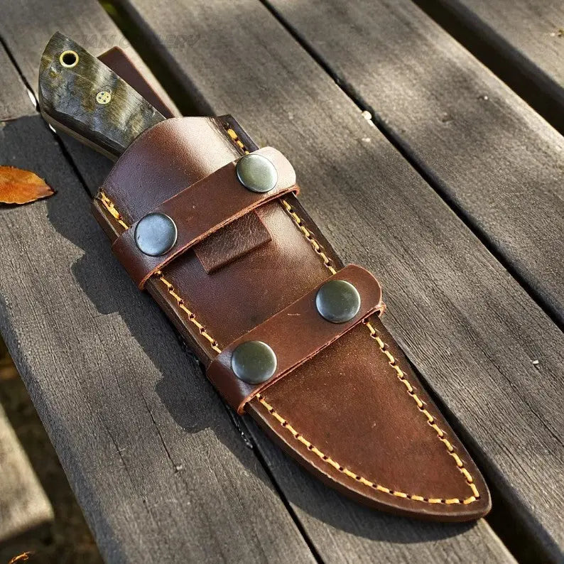 Handmade D2 steel hunting knife with ram horn handle, steel bolster, and leather sheath by Arham Cutlery