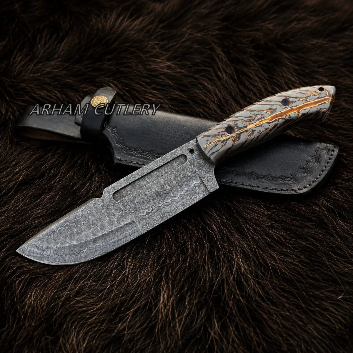 A fixed-blade knife with a patterned steel blade and a carved handle, shown with a black leather sheath on a dark brown fur background. The brand name 'ARHAM CUTLERY' is watermarked across the center.
