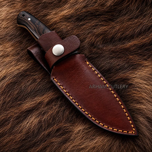 A fixed-blade knife with a dark wood handle and a brown leather sheath, displayed diagonally on a brown fur background. The sheath features contrast stitching and a silver snap button.