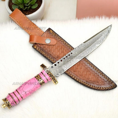 Damascus Steel Bowie Knife with Pink Turquoise Stone Handle and Brown Leather Sheath on White Fur Background