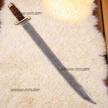 Cargar imagen en el visor de la galería, Hand-forged Damascus steel short sword with wooden handle and brass accents by Arham Cutlery, displayed on a wooden surface
