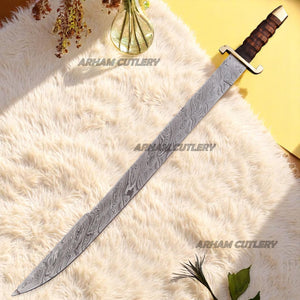 Hand-forged Damascus steel short sword with wooden handle and brass accents by Arham Cutlery, displayed on a wooden surface