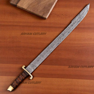 Hand-forged Damascus steel short sword with wooden handle and brass accents by Arham Cutlery, displayed on a wooden surface