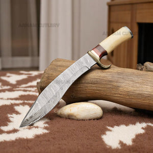 Handmade Damascus steel Bowie knife with bone and rosewood handle beside custom leather sheath – Arham Cutlery