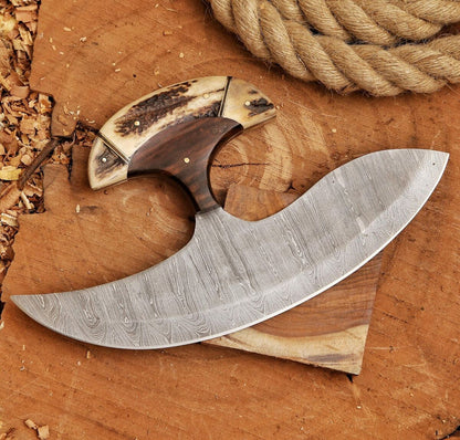 Decorative knife with wooden handle on a wooden surface