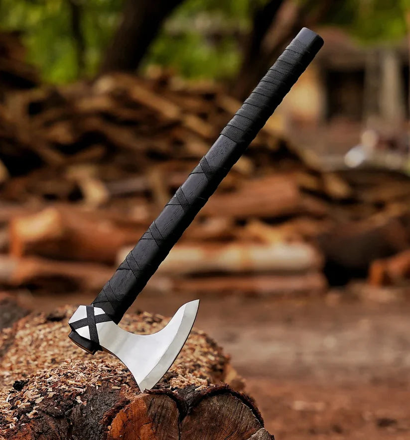 Axes on a wooden stump with blurred natural background