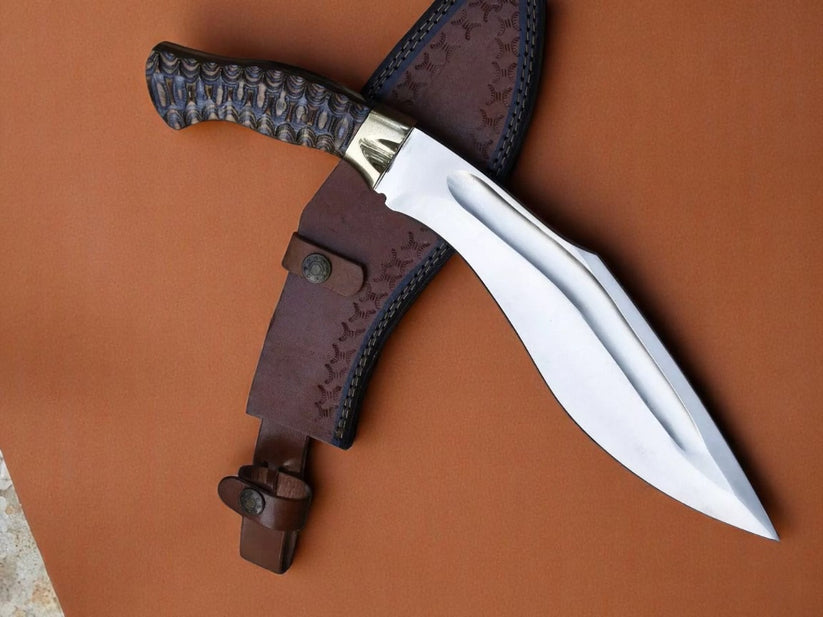 A fixed-blade knife with a textured dark handle and a polished silver blade, laid diagonally across a brown leather sheath on a warm brown background.