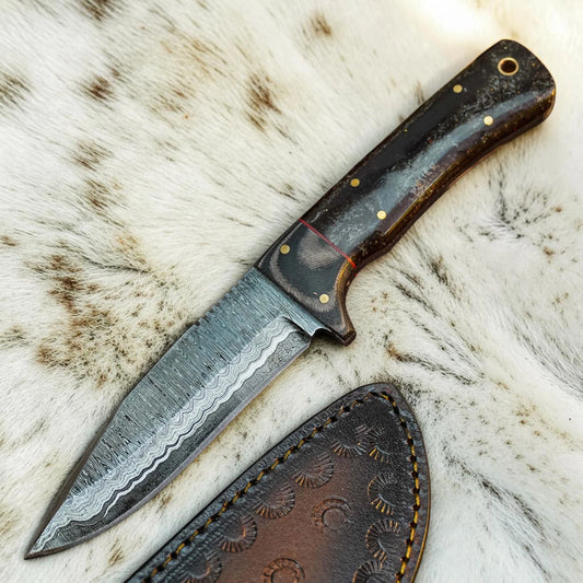 A fixed-blade knife with a patterned steel blade and a dark brown wooden handle with brass pins, shown alongside a brown leather sheath on a white and brown animal fur background.