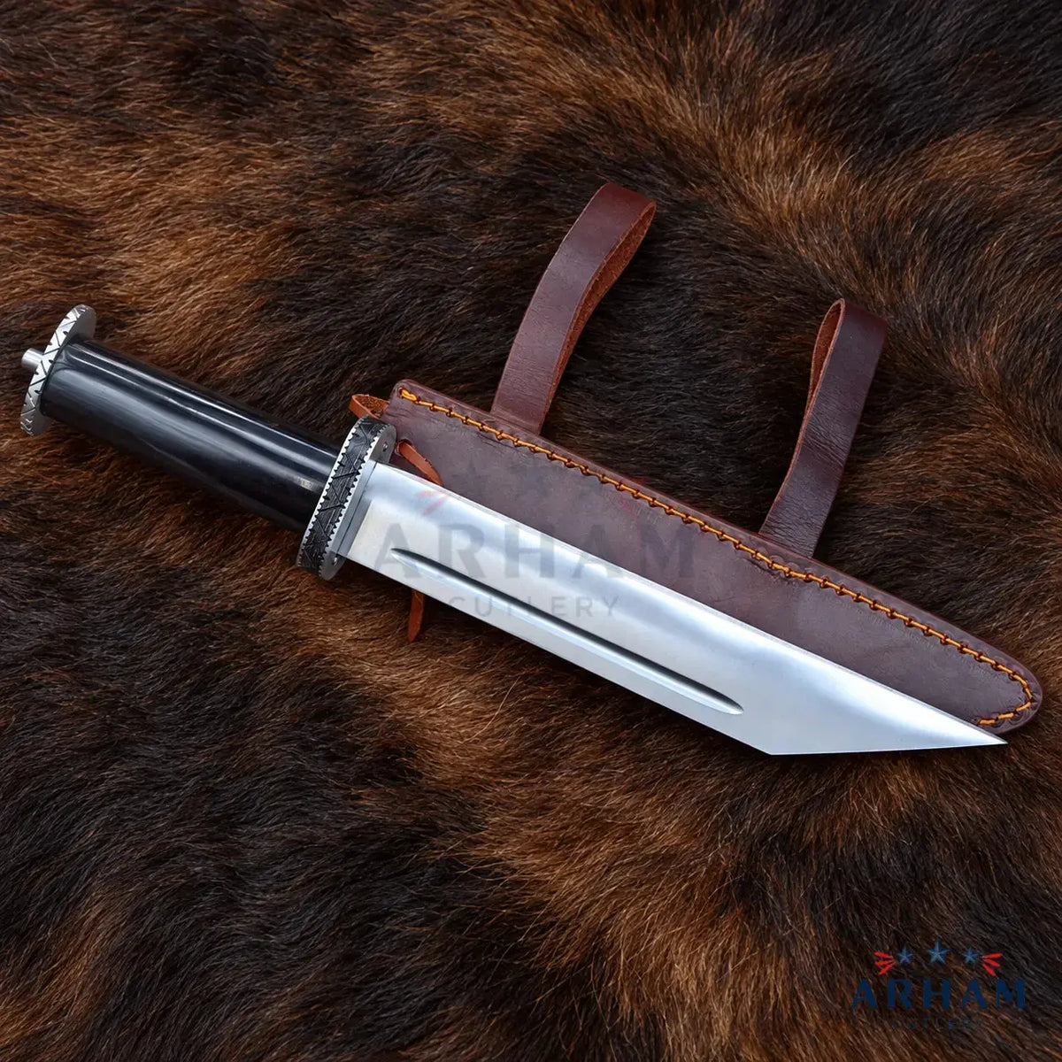 A fixed-blade knife with a polished silver blade, black handle, and silver guard is displayed diagonally next to its brown leather sheath on a brown fur background.