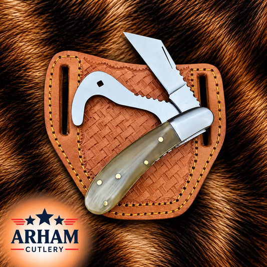 A folding knife with a silver blade and a curved bone handle rests inside a brown woven leather sheath, set against a brown fur background. The ARHAM CUTLERY logo is visible in the bottom-left corner.