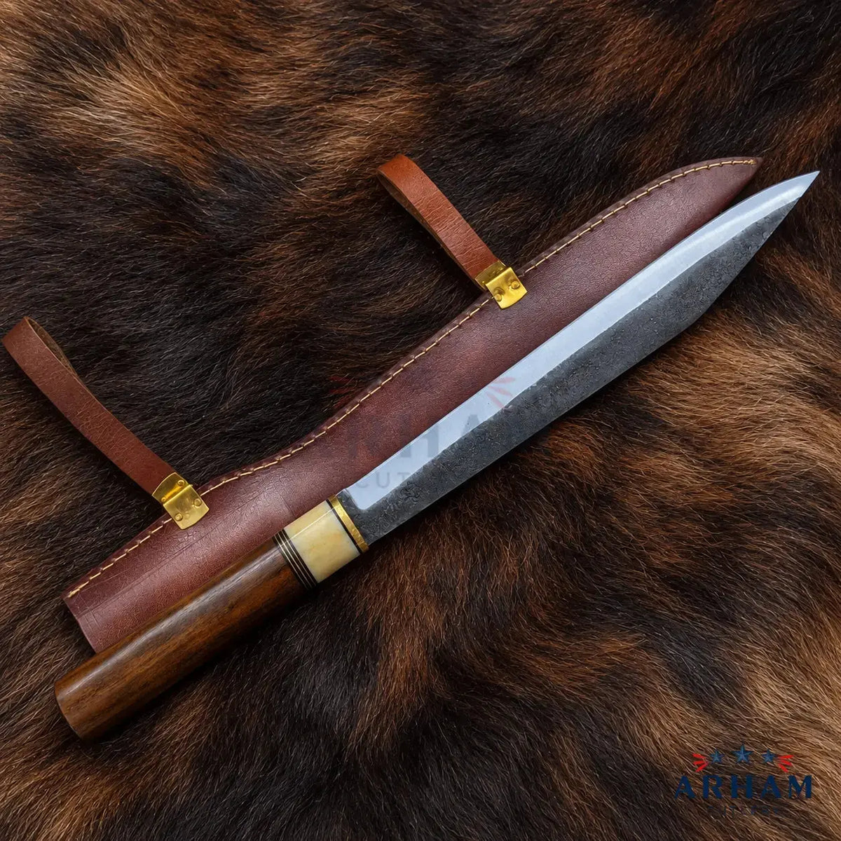 A fixed-blade knife with a dark wood handle and a textured steel blade, displayed diagonally on a brown leather sheath over a dark brown animal fur background. The knife features brass and bone-colored accents near the bolster.