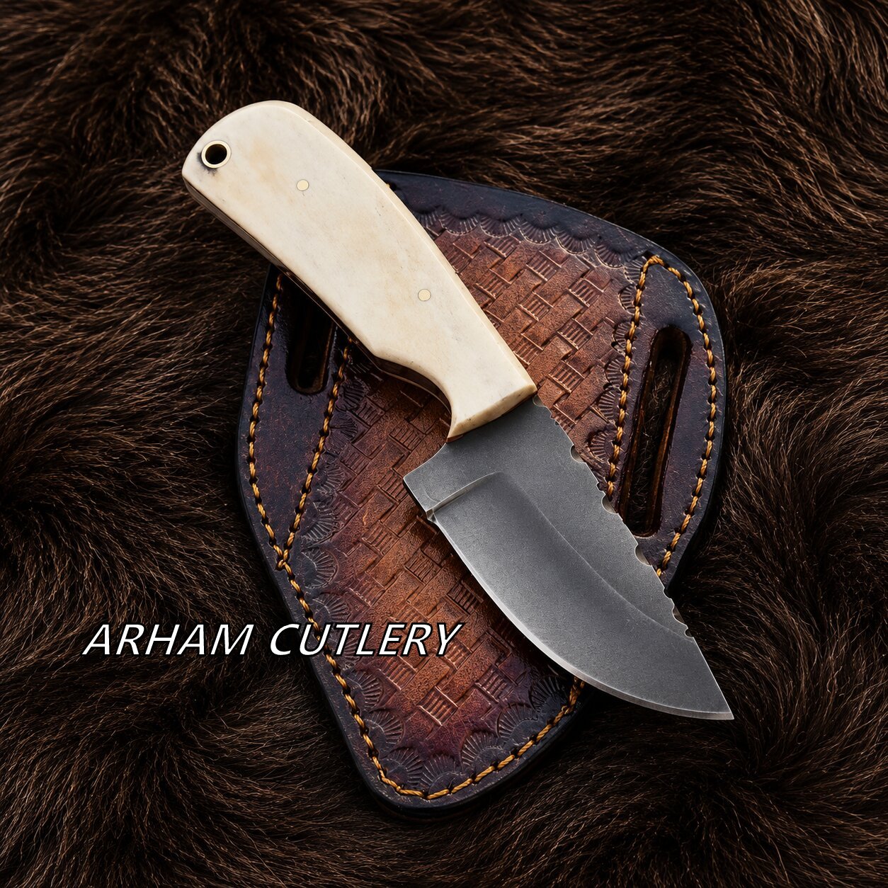 A fixed-blade knife with an ivory-colored handle and a dark steel blade, resting on a brown leather sheath over a dark brown fur background. The text 'ARHAM CUTLERY' is overlaid on the bottom left.