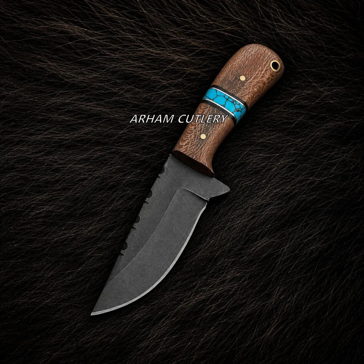 A fixed-blade knife with a dark gray steel blade and a brown wood handle featuring a turquoise inlay, displayed diagonally on a black textured fur background. The brand name 'ARHAM CUTLERY' is printed in white text across the handle.
