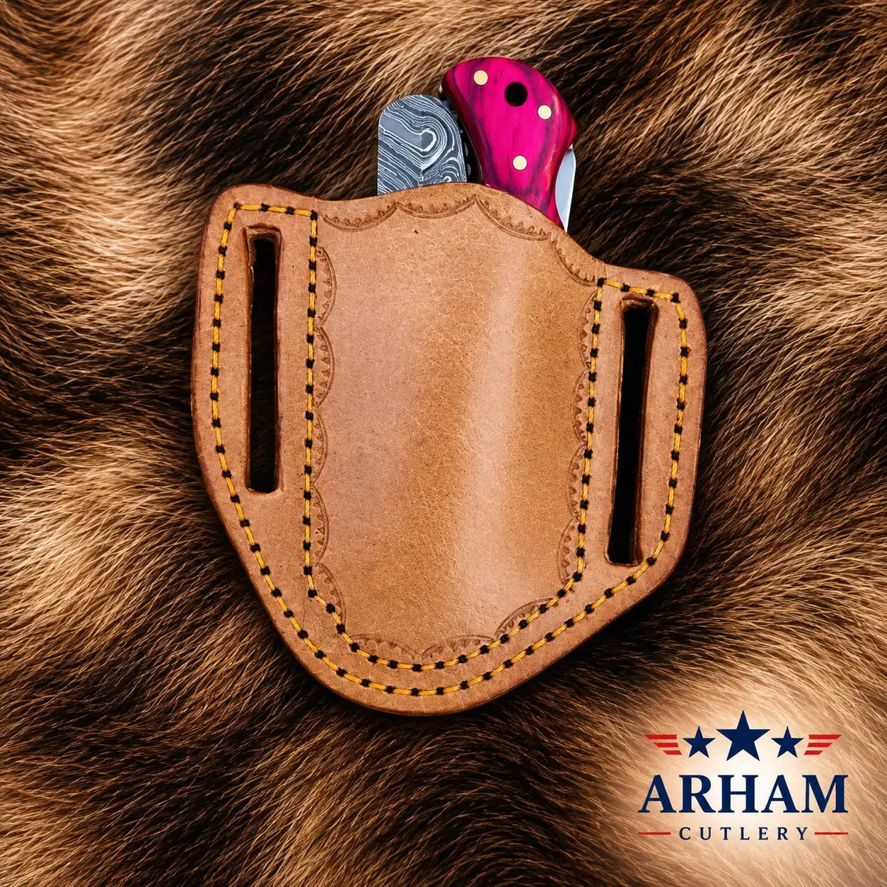 A tan leather knife holster with decorative stitching, shown holding two folding knives against a brown fur background. The Arham Cutlery logo is visible in the bottom right corner.