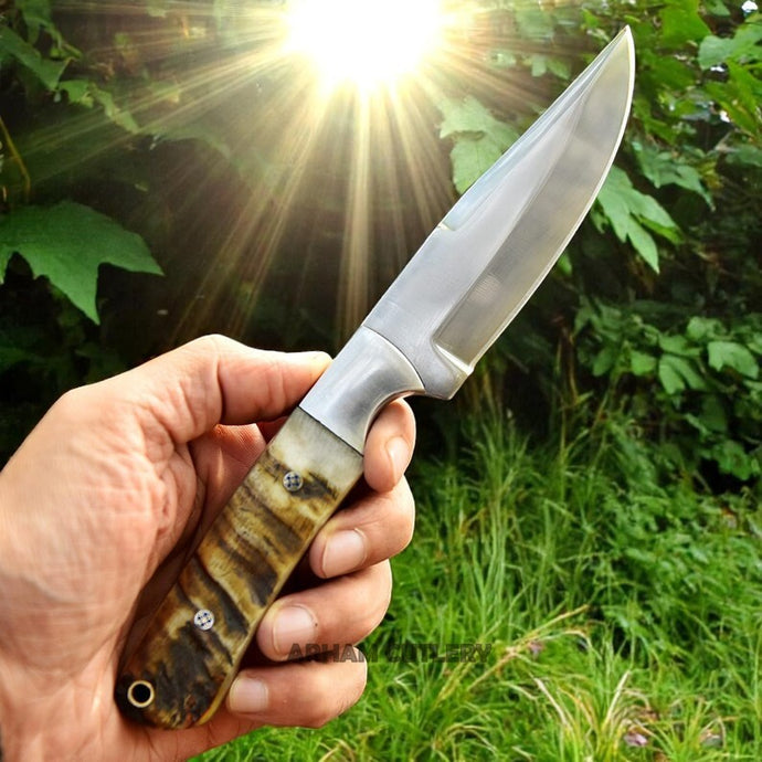Full view of handmade D2 steel hunting knife with ram horn handle held in hand – Arham Cutlery