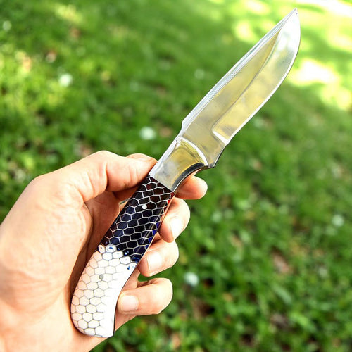 Handcrafted D2 steel knife with colorful honeycomb resin handle held outdoors – Arham Cutlery