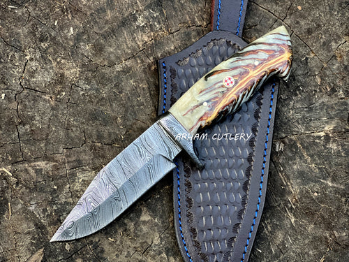 Handmade Damascus steel knife with pine cone resin handle and leather sheath by Arham Cutlery