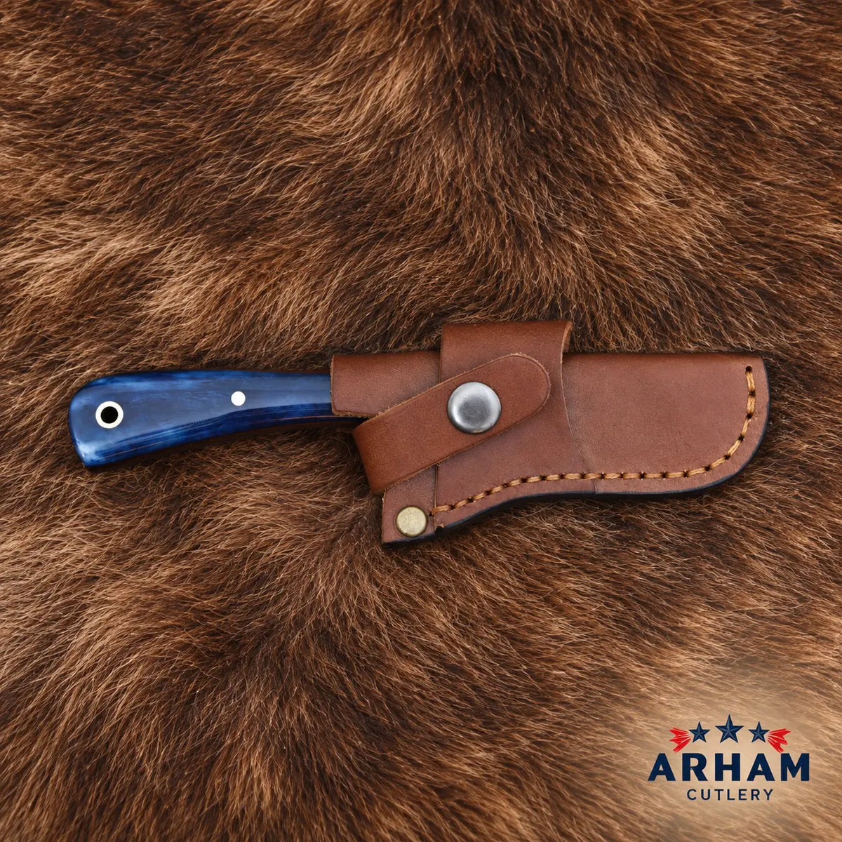 A fixed-blade knife with a blue marbled handle and a brown leather sheath, displayed on a brown fur background. The Arham Cutlery logo is visible in the bottom right corner.