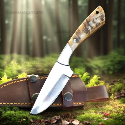 Handmade D2 steel hunting knife with ram horn handle, steel bolster, and leather sheath by Arham Cutlery