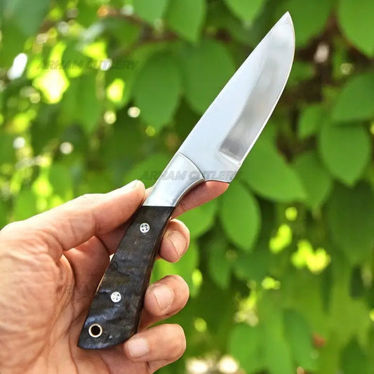 Handmade D2 steel hunting knife with ram horn handle, steel bolster, and leather sheath by Arham Cutlery