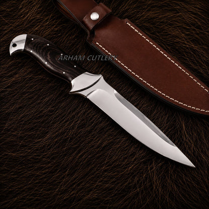 A fixed-blade knife with a polished silver blade, a dark wood handle, and a brown leather sheath, displayed on a dark brown textured fur background. The brand name 'ARHAM CUTLERY' is watermarked across the center.
