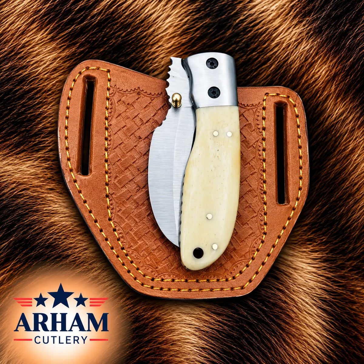 A folding pocket knife with a cream bone handle and silver steel blade is displayed in a brown leather sheath, set against a brown fur background. The ARHAM CUTLERY logo is visible in the bottom-left corner.