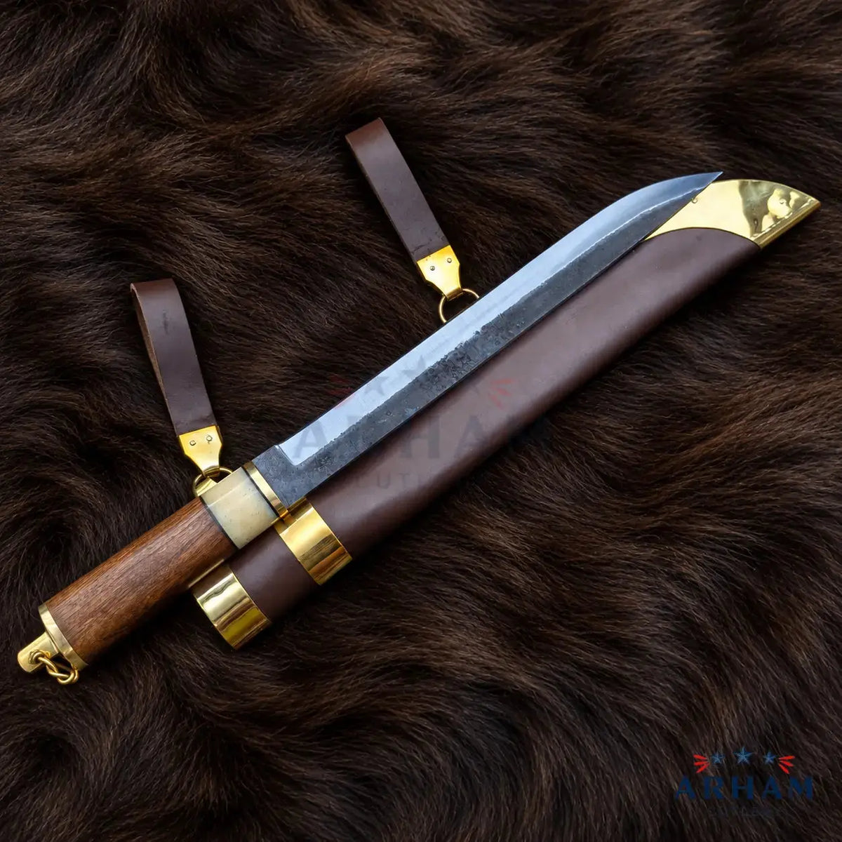 A fixed-blade knife with a textured steel blade, a brown wooden handle, and a brown leather sheath, displayed on a dark brown fur background. The sheath features brass/gold-colored metal accents and a matching leather loop with a brass ring.