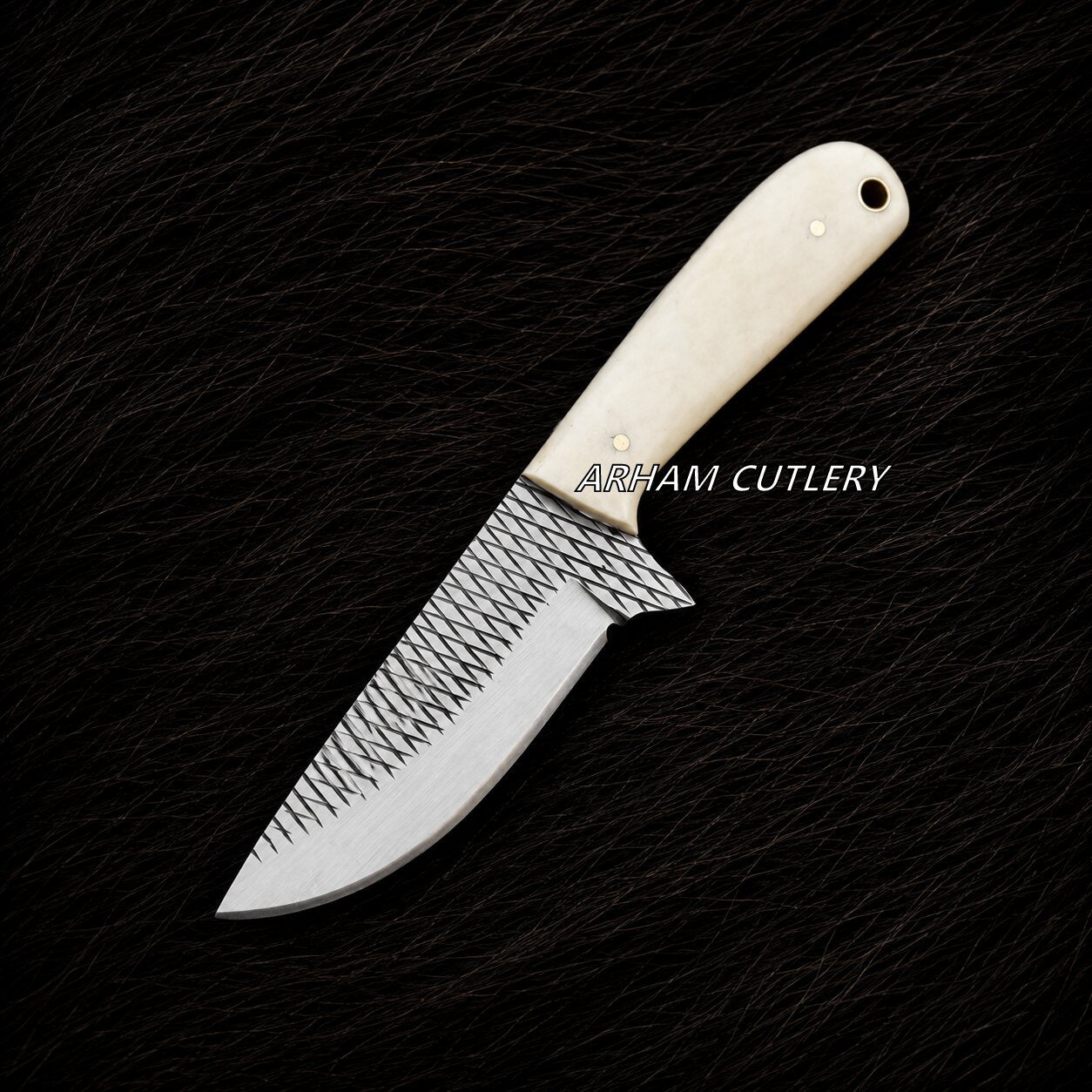 A fixed-blade knife with a textured, patterned silver blade and a cream-colored bone handle, displayed diagonally on a black textured background. The brand name 'ARHAM CUTLERY' is printed in white text over the handle.