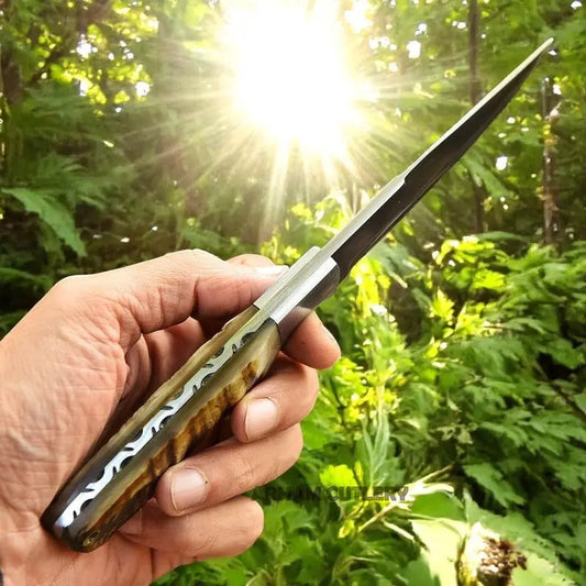 Close-up side profile of handmade D2 steel knife with ram horn handle outdoors – Arham Cutlery