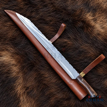 A large fixed-blade knife with a silver serrated blade, dark wood handle, and brown leather sheath, laid diagonally on a brown fur background.