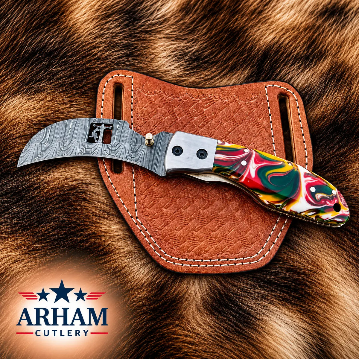 A folding pocket knife with a patterned steel blade and a colorful marbled handle, resting on a brown leather sheath over a brown fur background. The ARHAM CUTLERY logo is visible in the bottom-left corner.