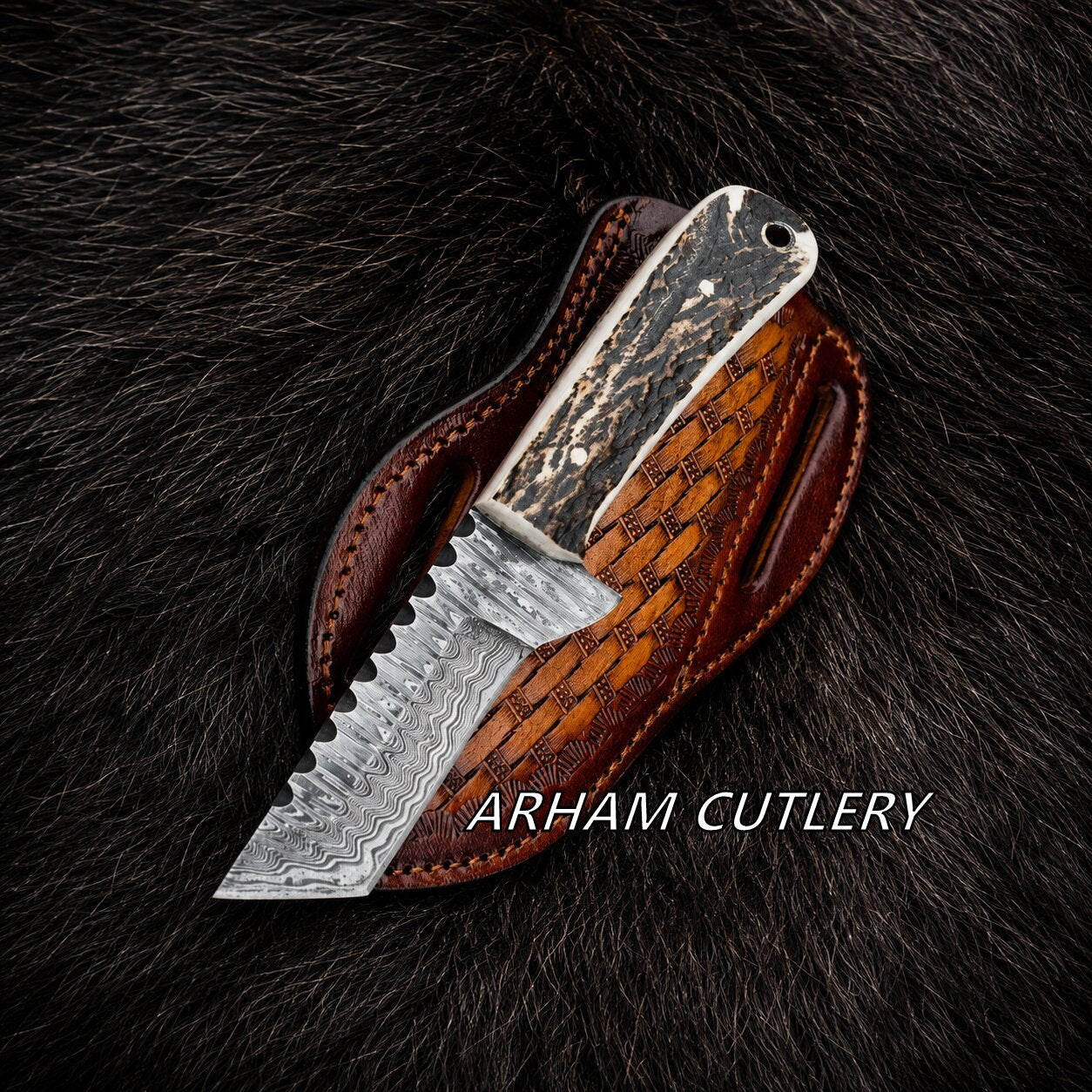 A fixed-blade knife with a patterned steel blade and textured handle, shown partially inserted into a brown leather sheath on a dark fur background. The text 'ARHAMI CUTLERY' is overlaid near the bottom.