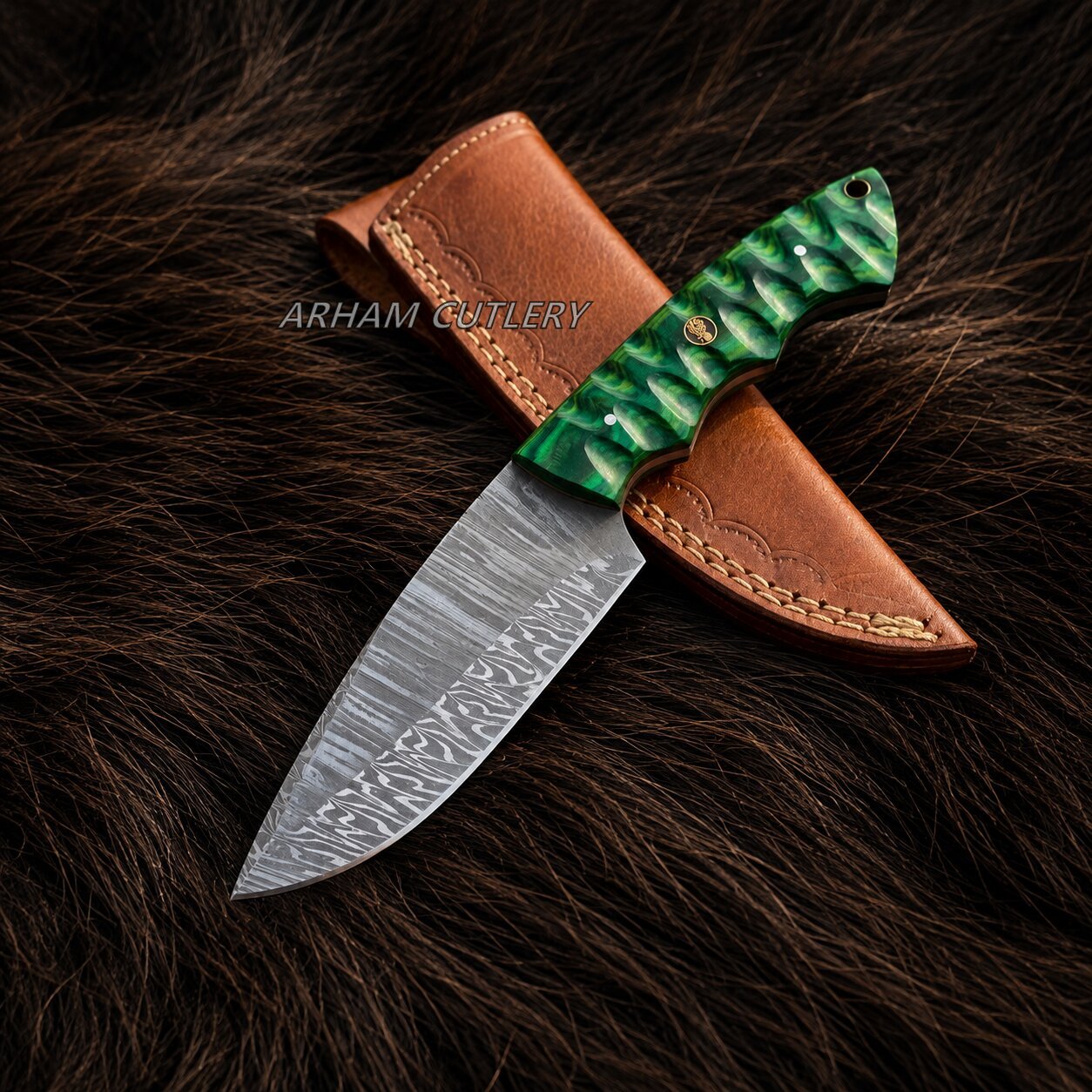 A fixed-blade knife with a patterned steel blade, a green textured handle, and a brown leather sheath, displayed on a dark brown fur background. The brand name 'ARHAM CUTLERY' is watermarked across the center.