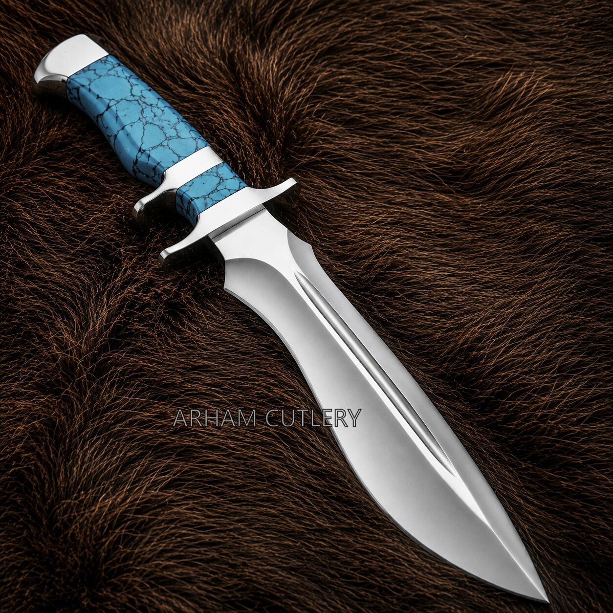 A fixed-blade knife with a polished silver steel blade and a textured turquoise blue handle with black veining, resting on a dark brown fur background. The brand name 'ARHAM CUTLERY' is watermarked across the center.