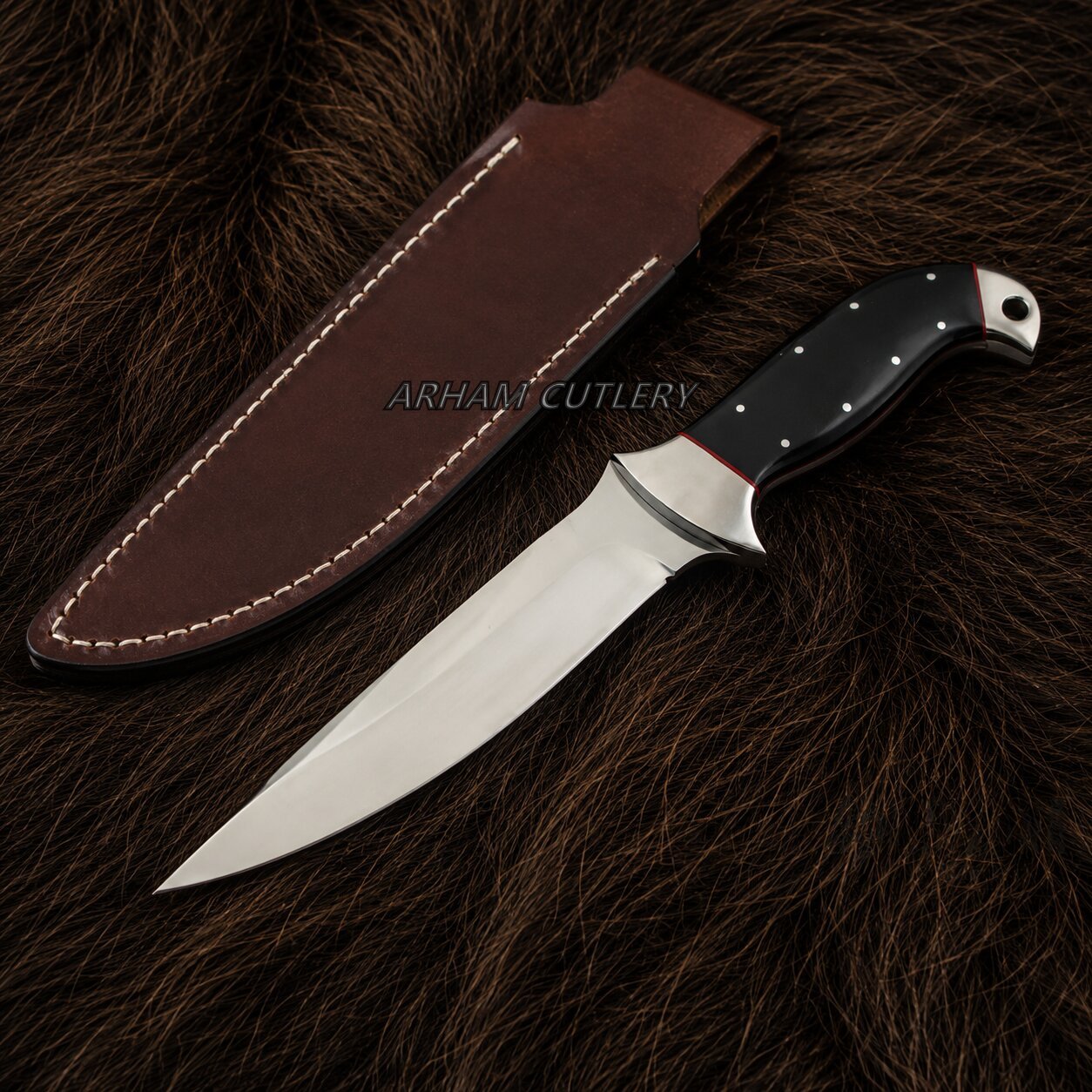 A fixed-blade knife with a silver steel blade, black handle with silver rivets, and a brown leather sheath, displayed on a dark brown fur background. The brand name 'ARHANT CUTLERY' is watermarked across the center.