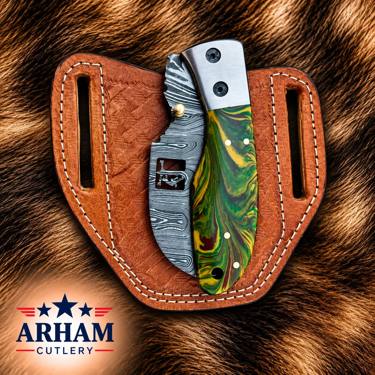 A folding pocket knife with a green and yellow marbled handle and a patterned steel blade, displayed in a brown leather sheath on a brown fur background. The ARHAM CUTLERY logo is visible in the bottom-left corner.