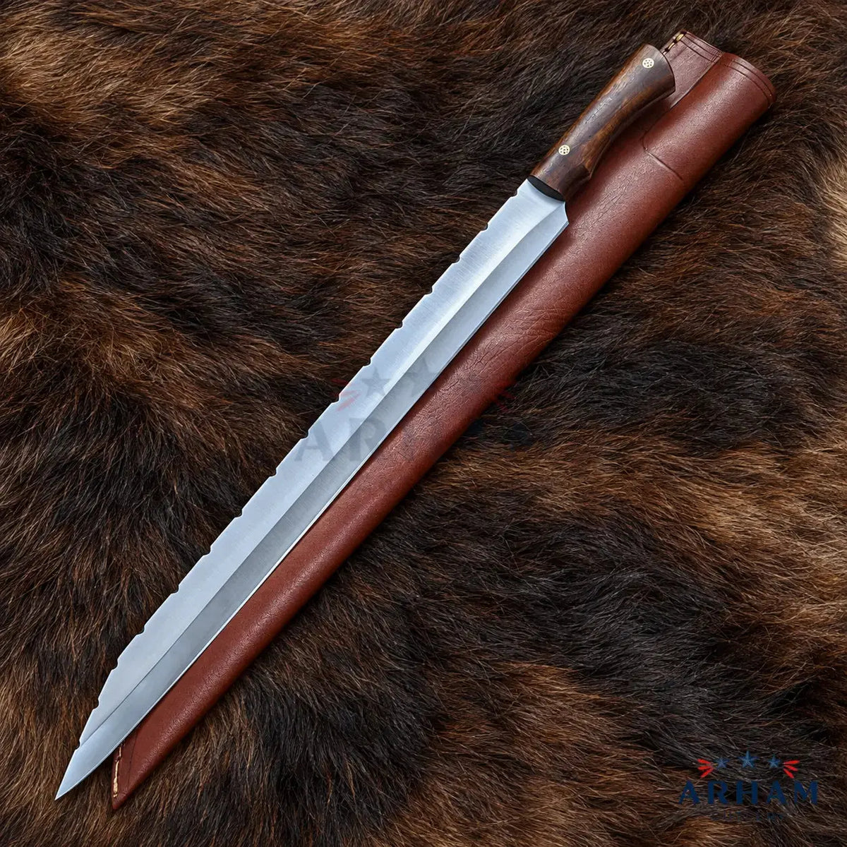 A long fixed-blade knife with a silver steel blade and dark brown wooden handle, shown alongside a brown leather sheath on a brown animal fur background. A small 'Artem' logo is visible in the bottom right corner.
